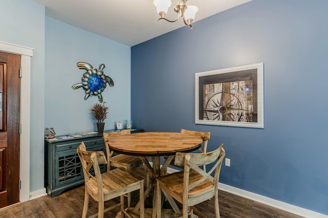 dining area featuring baseboards, an inviting chandelier, and dark wood-style flooring