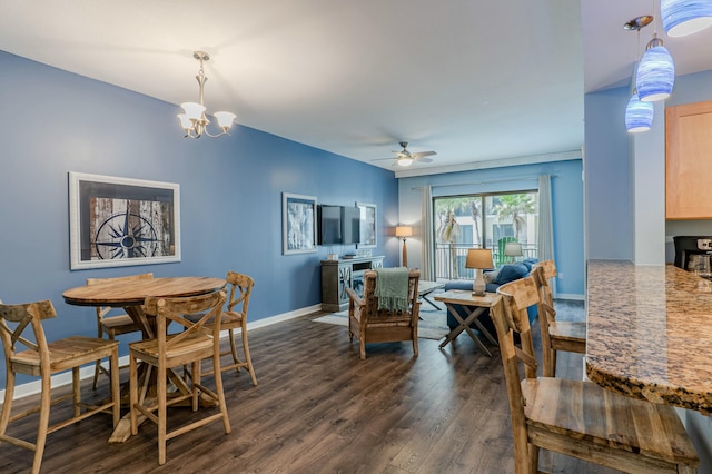 dining space featuring baseboards, dark wood finished floors, and ceiling fan with notable chandelier