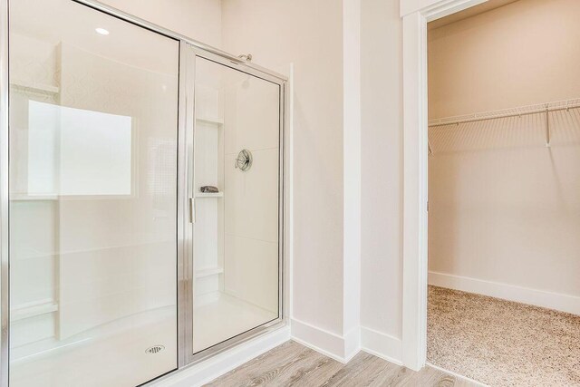 8598 Bluebell St, Milton, FL 32583 - full bath with a shower stall, a spacious closet, and baseboards