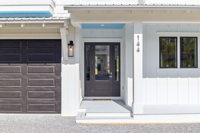 144 Dalton Dr, Santa Rosa Beach, FL 32459 - view of exterior entry with metal roof and a garage