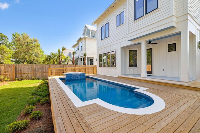 144 Dalton Dr, Santa Rosa Beach, FL 32459 - view of pool featuring a lawn, a deck, a pool with connected hot tub, and a fenced backyard