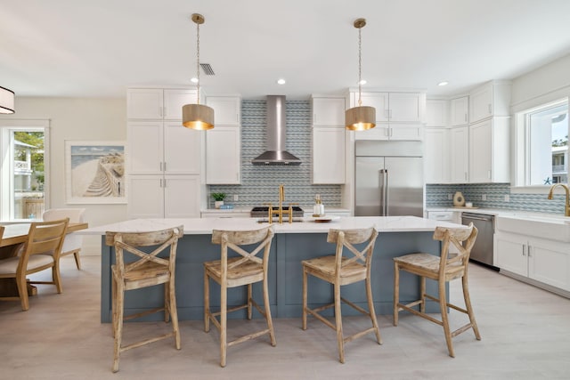 144 Dalton Dr, Santa Rosa Beach, FL 32459 - kitchen with wall chimney range hood, a sink, decorative backsplash, and appliances with stainless steel finishes