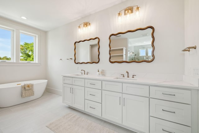 144 Dalton Dr, Santa Rosa Beach, FL 32459 - full bath with baseboards, a freestanding tub, double vanity, and a sink