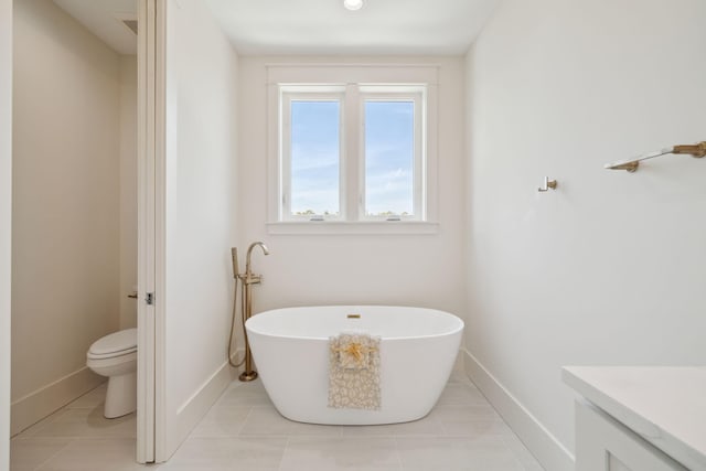 144 Dalton Dr, Santa Rosa Beach, FL 32459 - bathroom with vanity, tile patterned floors, toilet, baseboards, and a soaking tub