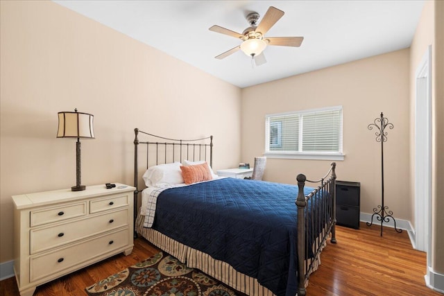 bedroom with baseboards, a ceiling fan, and wood finished floors