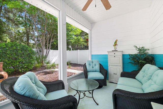 sunroom featuring ceiling fan
