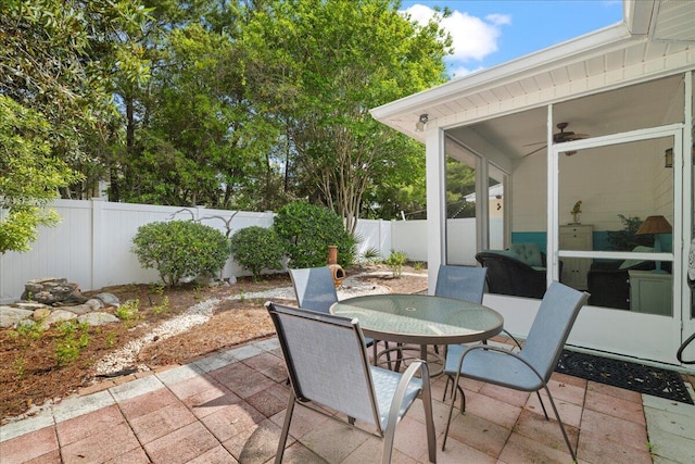 view of patio with a fenced backyard, outdoor dining area, and ceiling fan