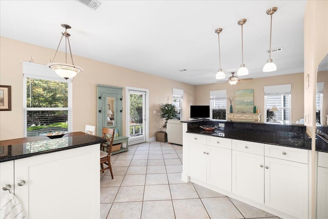 kitchen with visible vents, white cabinetry, a wealth of natural light, and dark countertops