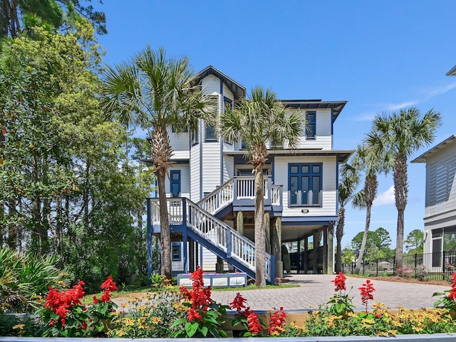 182 My Way, Santa Rosa Beach, FL 32459 - coastal inspired home with fence, driveway, stairway, and a carport