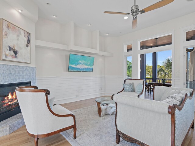 182 My Way, Santa Rosa Beach, FL 32459 - living area featuring ceiling fan, wainscoting, wood finished floors, and a fireplace