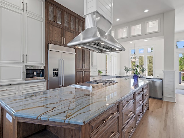 182 My Way, Santa Rosa Beach, FL 32459 - kitchen with a large island, island range hood, white cabinetry, light wood finished floors, and appliances with stainless steel finishes