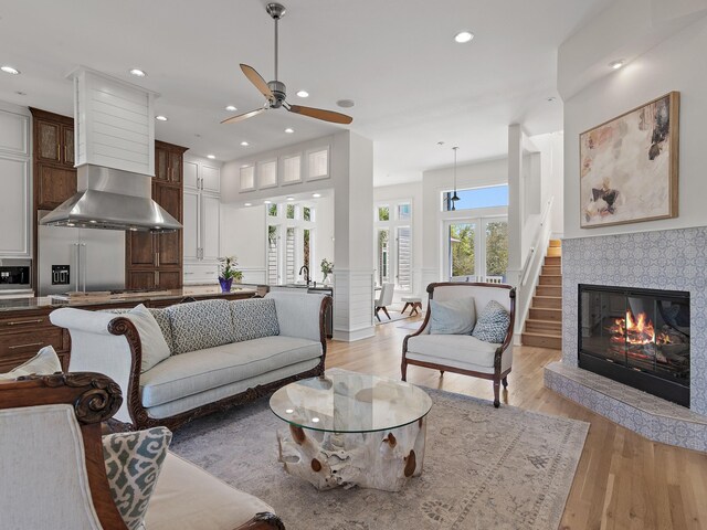 182 My Way, Santa Rosa Beach, FL 32459 - living room with wainscoting, a fireplace, ceiling fan, recessed lighting, and light wood-style flooring