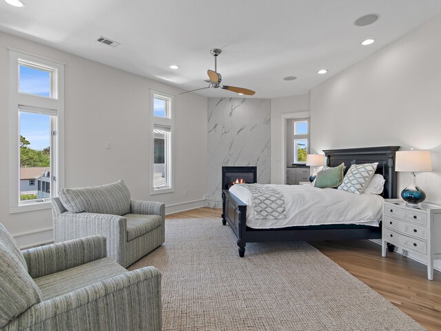 182 My Way, Santa Rosa Beach, FL 32459 - bedroom with ceiling fan, visible vents, a fireplace, wood finished floors, and recessed lighting