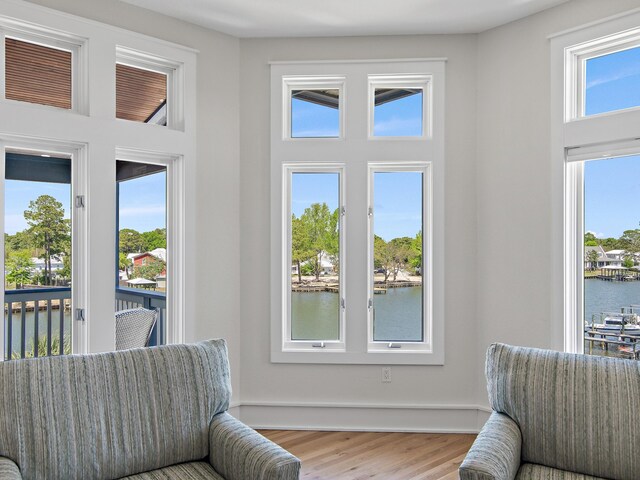 182 My Way, Santa Rosa Beach, FL 32459 - interior space with a healthy amount of sunlight, a water view, a high ceiling, and wood finished floors