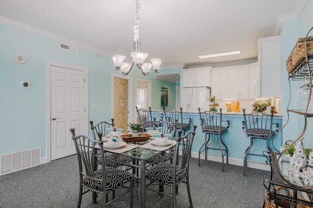 17545 Front Beach Rd Unit 1507, Panama City Beach, FL 32413 - dining space with crown molding, a chandelier, and dark colored carpet