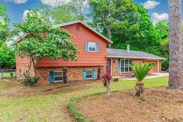 11 Birch Ave, Shalimar, FL 32579 - split level home featuring a garage, brick siding, fence, and a front lawn