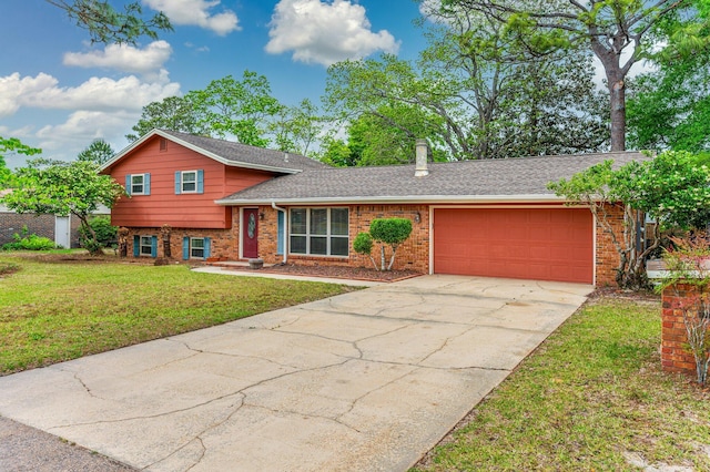11 Birch Ave, Shalimar, FL 32579 - split level home with a front yard, concrete driveway, a garage, and brick siding
