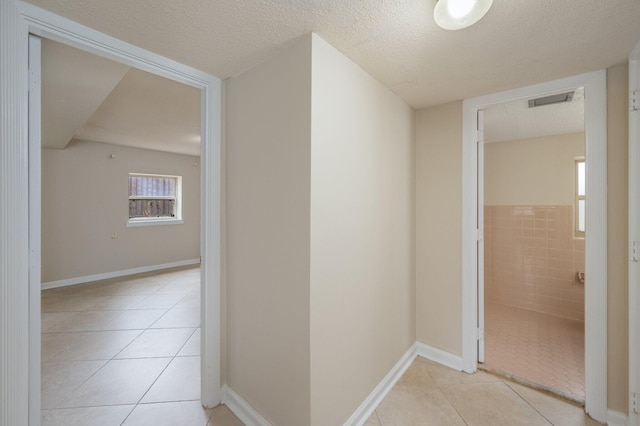 11 Birch Ave, Shalimar, FL 32579 - corridor featuring light tile patterned floors, visible vents, and a textured ceiling
