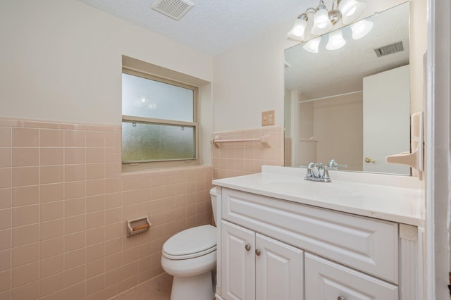 11 Birch Ave, Shalimar, FL 32579 - bathroom featuring visible vents, toilet, vanity, and tile walls