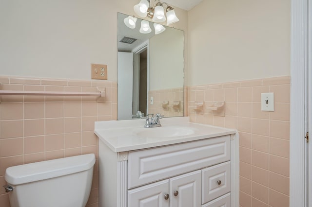 11 Birch Ave, Shalimar, FL 32579 - half bathroom with tile walls, a chandelier, vanity, toilet, and visible vents
