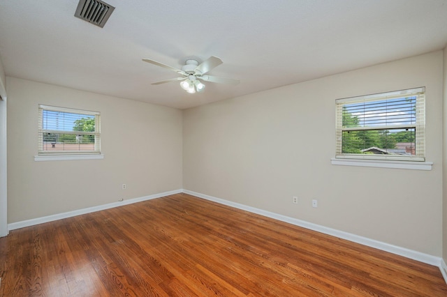 11 Birch Ave, Shalimar, FL 32579 - spare room featuring a ceiling fan, baseboards, wood finished floors, and plenty of natural light