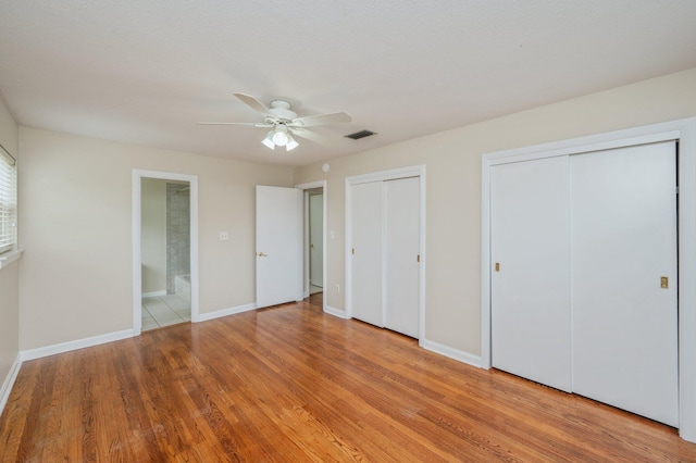 11 Birch Ave, Shalimar, FL 32579 - unfurnished bedroom featuring light wood-style flooring, two closets, baseboards, visible vents, and a ceiling fan