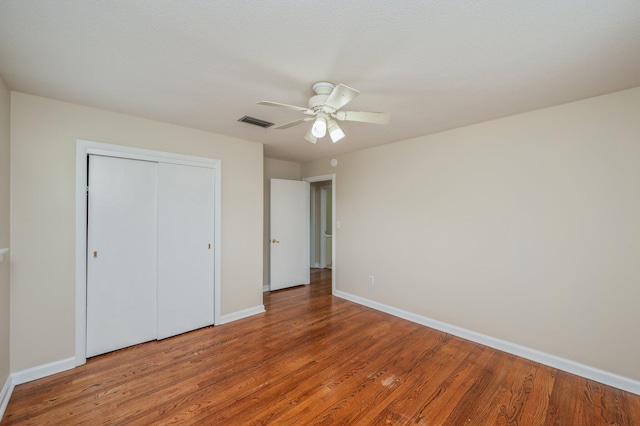 11 Birch Ave, Shalimar, FL 32579 - unfurnished bedroom with a closet, a ceiling fan, visible vents, baseboards, and wood finished floors