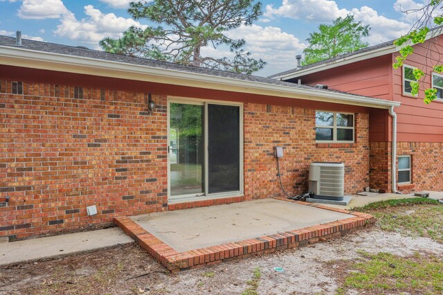 11 Birch Ave, Shalimar, FL 32579 - back of property featuring brick siding, central air condition unit, and a patio area
