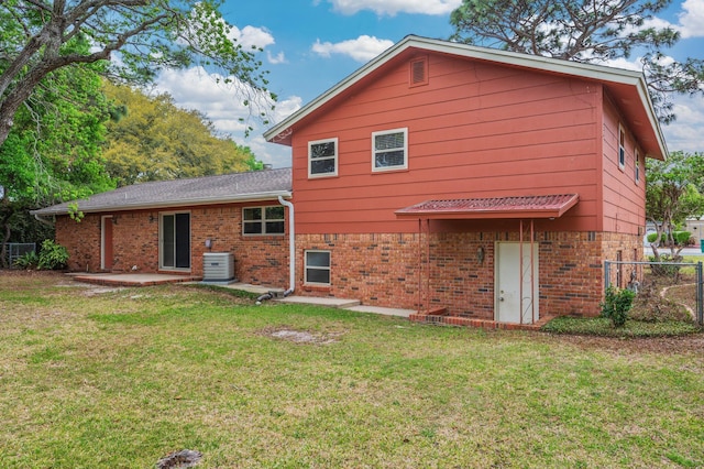 11 Birch Ave, Shalimar, FL 32579 - rear view of house with fence, a yard, central air condition unit, and brick siding