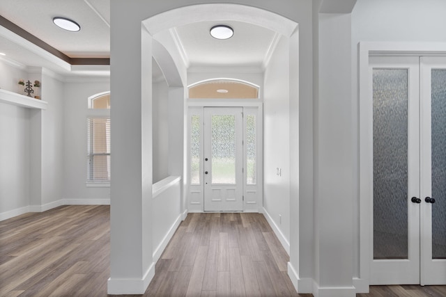 129 Red Maple Way, Niceville, FL 32578 - entrance foyer with crown molding, wood finished floors, french doors, arched walkways, and baseboards