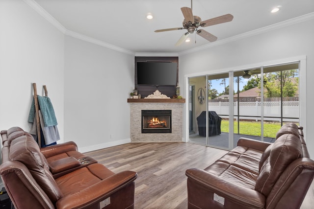 129 Red Maple Way, Niceville, FL 32578 - living room featuring a ceiling fan, wood finished floors, recessed lighting, crown molding, and a stone fireplace