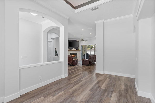 129 Red Maple Way, Niceville, FL 32578 - empty room featuring ceiling fan, ornamental molding, a lit fireplace, wood finished floors, and baseboards