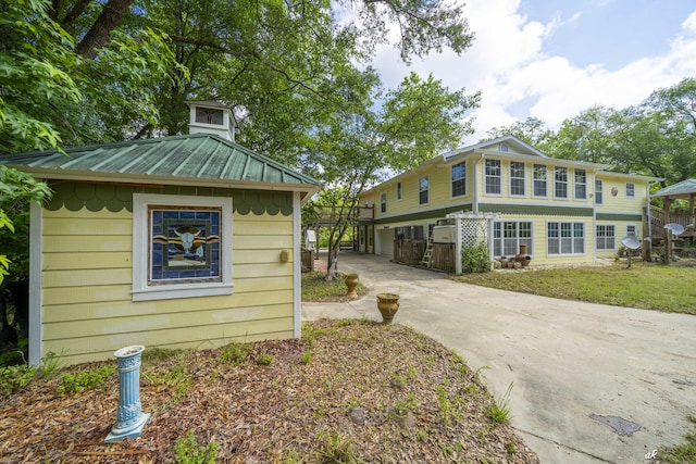 7930 Bunker Rd, Vernon, FL 32462 - view of side of home featuring metal roof, driveway, and a standing seam roof