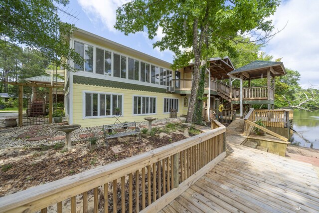 7930 Bunker Rd, Vernon, FL 32462 - wooden terrace with stairway, a water view, a sunroom, and a gazebo