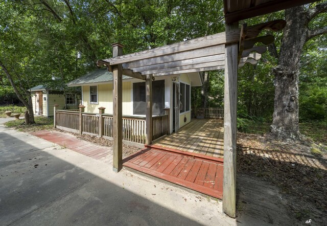7930 Bunker Rd, Vernon, FL 32462 - view of patio with a wooden deck, an outdoor structure, and view of wooded area