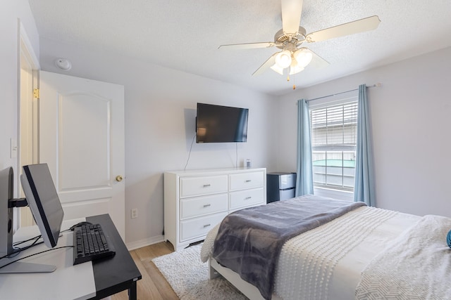 119 Red Bay Ct, Santa Rosa Beach, FL 32459 - bedroom featuring light wood finished floors, ceiling fan, baseboards, and a textured ceiling
