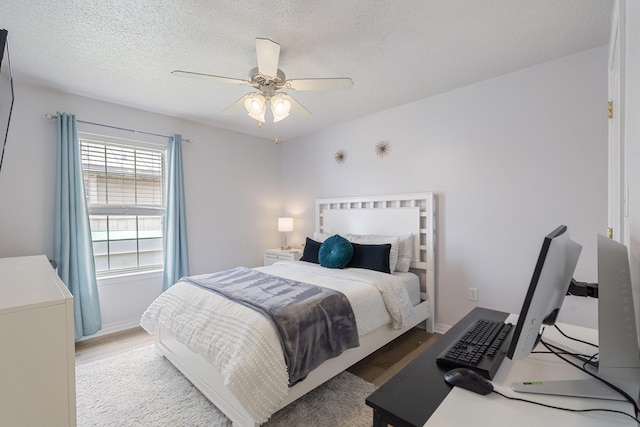 119 Red Bay Ct, Santa Rosa Beach, FL 32459 - bedroom featuring light wood-style floors, ceiling fan, a textured ceiling, and baseboards