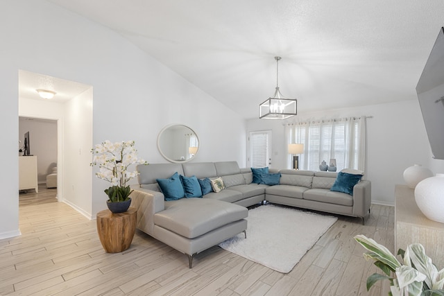 119 Red Bay Ct, Santa Rosa Beach, FL 32459 - living area featuring a chandelier, light wood-type flooring, vaulted ceiling, and baseboards