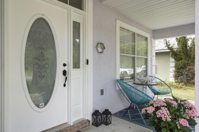 119 Red Bay Ct, Santa Rosa Beach, FL 32459 - property entrance featuring a porch and stucco siding