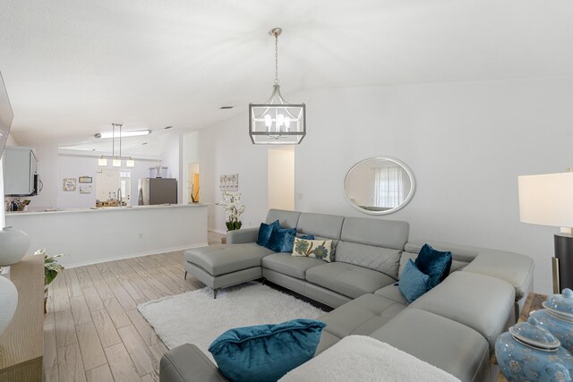 119 Red Bay Ct, Santa Rosa Beach, FL 32459 - living area with a chandelier, wood finished floors, baseboards, and lofted ceiling