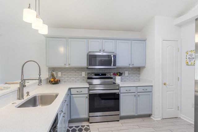 119 Red Bay Ct, Santa Rosa Beach, FL 32459 - kitchen featuring appliances with stainless steel finishes, a sink, tasteful backsplash, and light countertops