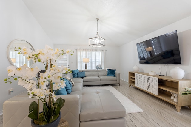 119 Red Bay Ct, Santa Rosa Beach, FL 32459 - living room with a chandelier, wood finished floors, lofted ceiling, and baseboards