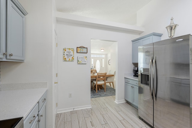 119 Red Bay Ct, Santa Rosa Beach, FL 32459 - kitchen featuring stainless steel fridge with ice dispenser, light wood-style flooring, stove, and gray cabinetry