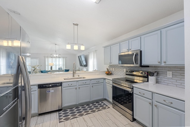119 Red Bay Ct, Santa Rosa Beach, FL 32459 - kitchen with appliances with stainless steel finishes, a sink, decorative backsplash, gray cabinetry, and light countertops