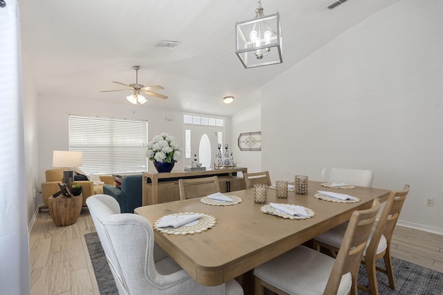 119 Red Bay Ct, Santa Rosa Beach, FL 32459 - dining room featuring lofted ceiling, baseboards, a ceiling fan, a chandelier, and light wood-style flooring