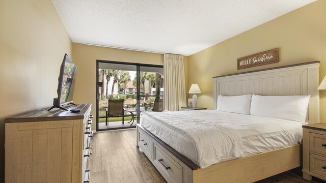 520 N Richard Jackson Blvd Unit 952, Panama City Beach, FL 32407 - bedroom with access to outside and dark wood-type flooring