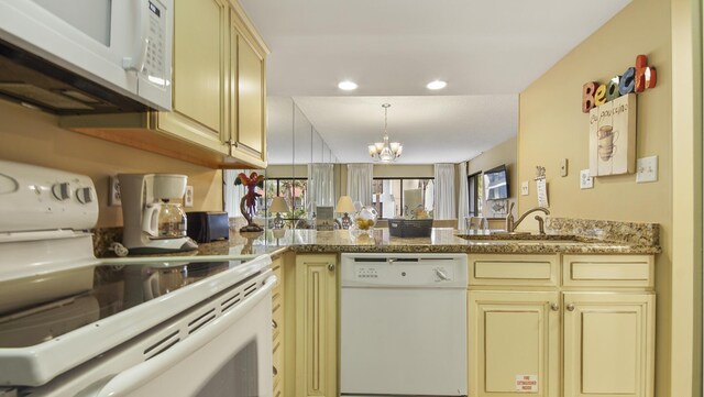 520 N Richard Jackson Blvd Unit 952, Panama City Beach, FL 32407 - kitchen featuring a chandelier, white appliances, cream cabinetry, and a sink