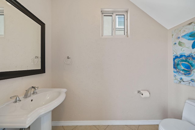 229 Inverrary Dr, Destin, FL 32541 - half bathroom with tile patterned flooring, toilet, baseboards, a sink, and vaulted ceiling