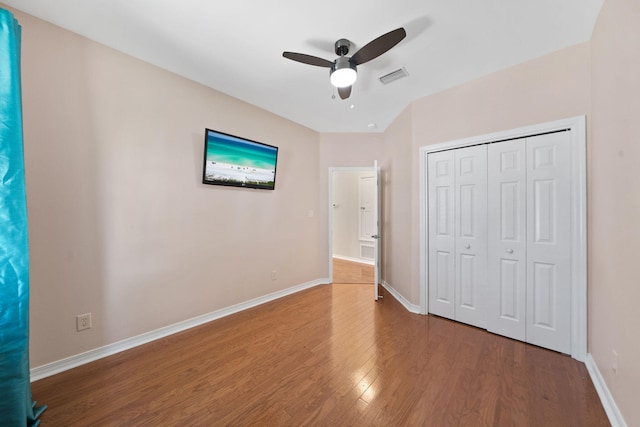 229 Inverrary Dr, Destin, FL 32541 - unfurnished bedroom featuring baseboards, visible vents, wood finished floors, and a closet