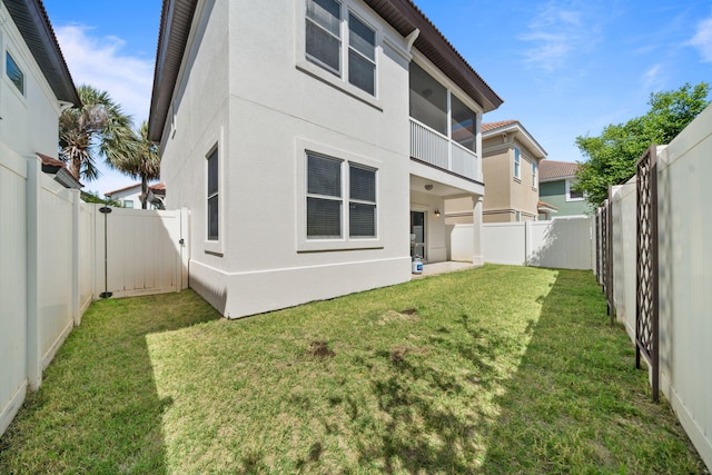 229 Inverrary Dr, Destin, FL 32541 - back of house with a lawn, stucco siding, and a fenced backyard
